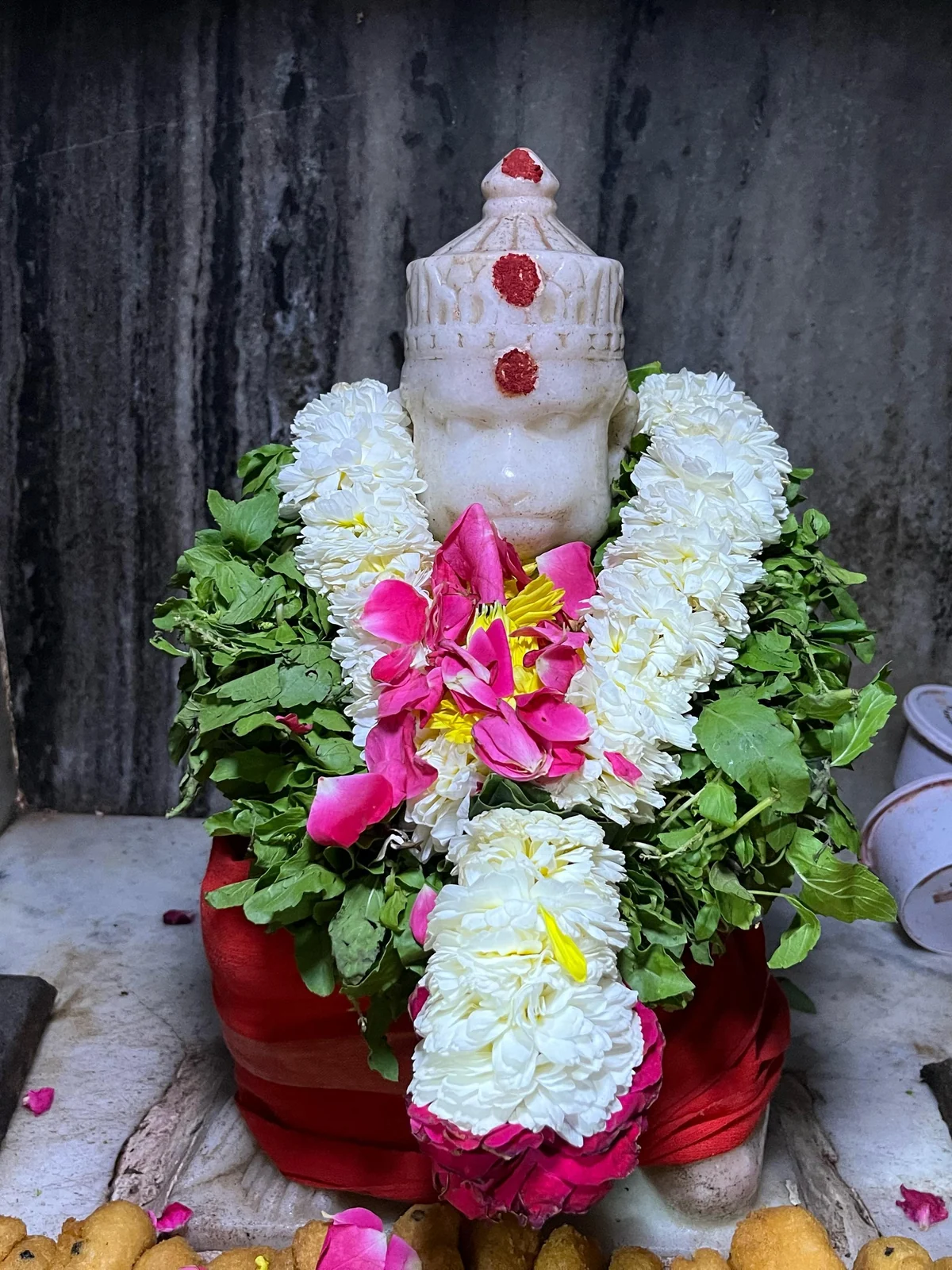 Sri Anjaneya adorned with flowers and a traditional vada mala offering