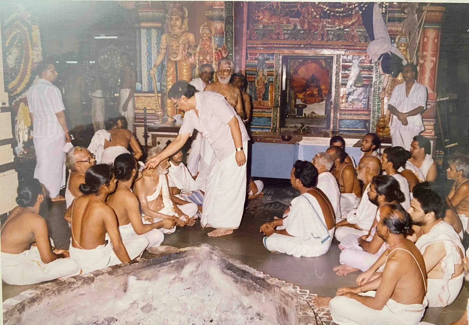 Archival Vedic ceremony with priests and devotees inside the temple